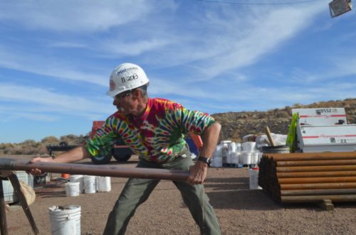 Coauthor John Geissman of the University of Texas, Dallas, pulls a drilled-out core of rock used in the study. The drilling penetrated more than 1,500 feet, going back some 250 million years.